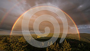 Dreamlike rainbow after a summer thunderstorm shortly before the sun goes down