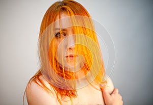 Dreammy fashion portrait of redhead woman in soft focus