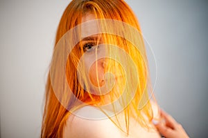 Dreammy fashion portrait of redhead woman in soft focus
