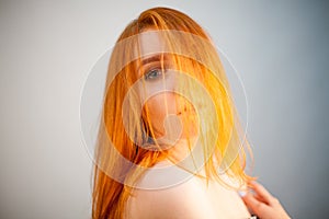 Dreammy fashion portrait of redhead woman in soft focus