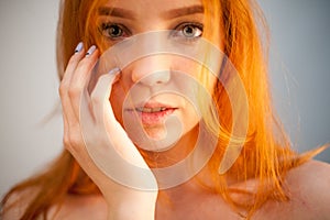 Dreammy gorgeous portrait of redhead woman in soft focus