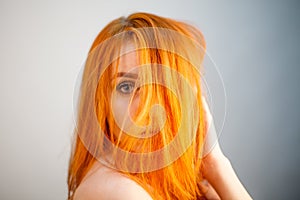 Dreammy portrait of bright redhead woman in soft focus