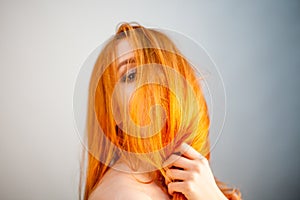 Dreammy portrait of bright redhead woman in soft focus