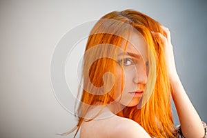 Dreammy portrait of fashion redhead woman in soft focus