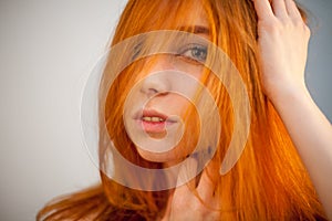 Dreammy portrait of shy redhead woman in soft focus