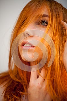 Dreammy portrait of shy redhead woman in soft focus