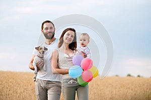 Happy family and dog enjoy outdoor time together