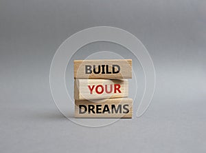 Dreams symbol. Concept word Build your Dreams on wooden blocks. Beautiful grey background. Business and Build your Dreams concept