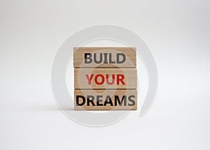 Dreams symbol. Concept word Build your Dreams on wooden blocks. Beautiful white background. Business and Build your Dreams concept
