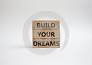 Dreams symbol. Concept word Build your Dreams on wooden blocks. Beautiful white background. Business and Build your Dreams concept