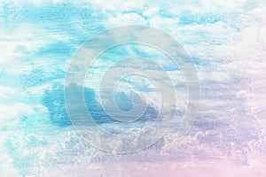 dreamy and abstract image of the blue sky with white clouds. double exposure effect with watercolor brush stroke texture.