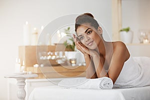 Dreamy beautiful girl in towel resting in spa salon.