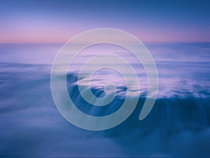 dreamy and beautiful seascape with rock and long exposure on beach