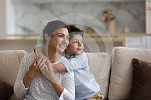 Dreamy bonding mixed race family visualizing future.