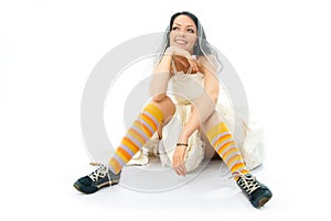 Dreamy bride wearing running shoes and socks