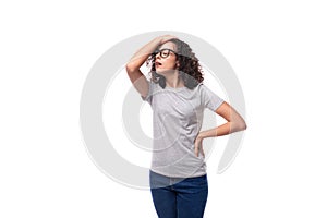 dreamy caucasian young brunette woman with shoulder-length curly hair on a white background with copy space