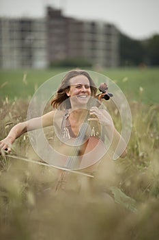 Dreamy celloplayer in nature