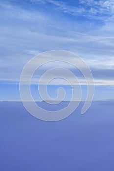 Dreamy fluffy cloudscape from airplane porthole