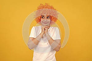 dreamy freaky woman in curly clown wig for party, dreaming