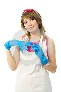 Dreamy housewife putting on rubber gloves