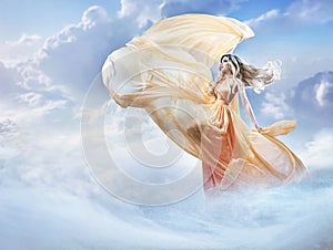 Dreamy image of a beautiful young lady in the clouds