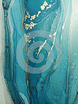 Luxury abstract fluid art painting background alcohol ink technique mint blue and gold. Marble texture photo