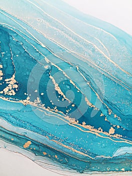 Luxury abstract fluid art painting background alcohol ink technique mint blue and gold. Marble texture photo