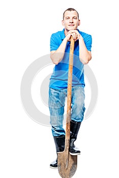 Dreamy laborer with a shovel on a white background