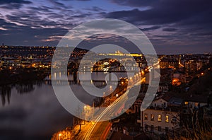 Dreamy night view of Vltava river with magical sky and lights from streets and bridges on sunset.