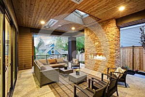 Dreamy outdoor covered patio with stone fireplace photo