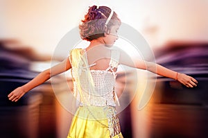 Dreamy portrait of small little girl open arms rear view