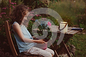 dreamy romantic kid girl relaxing in evening summer garden