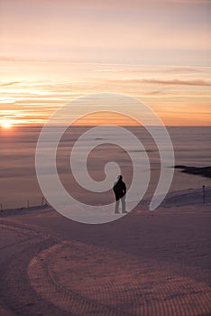 Dreamy sky. Amazing sunset, snow all around, skiing resort beauty.