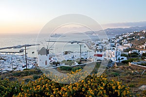 Dreamy sunset over Mykonos town and a traditional windmill, Cyclades, Greece