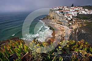 Dreamy view of the picturesque village Azenhas do Mar ins sunset light with chalk houses on the edge of a cliff and