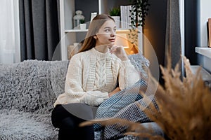 Dreamy woman on couch