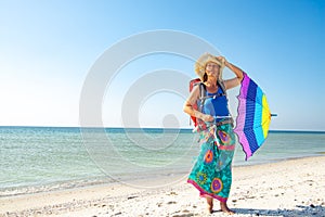 Dreamy woman in a pareo with umbrella