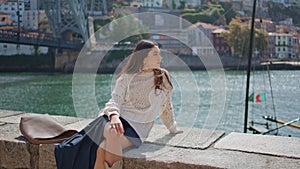 Dreamy woman relaxing sunny promenade alone. Romantic girl looking camera posing