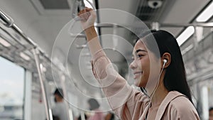 Dreamy Woman Rides Tram and Listens to Music in Headphones.