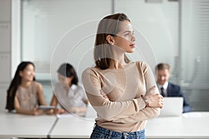 Dreamy young business woman professional looking away dreaming of success