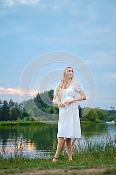 Dreamy young woman by the river