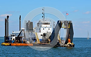 Dredger ship working at sea photo