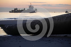 A dredger supplying sand to a beach