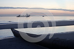 A dredger supplying sand to a beach