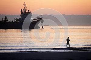 A dredger supplying sand to a beach