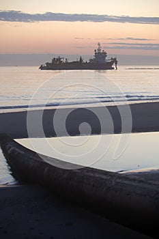 A dredger supplying sand to a beach