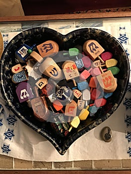 Dreidels in a Heart Shaped Container for Hanukkah Ce