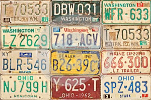 Retro styled image of old car license plates on a wall