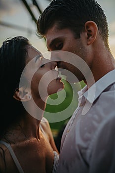 Couple in love kisses and embraces under drops of rain