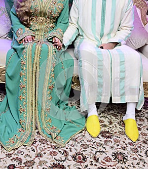 Dress the bride and groom in the wedding. Caftan Moroccan and Jellaba photo